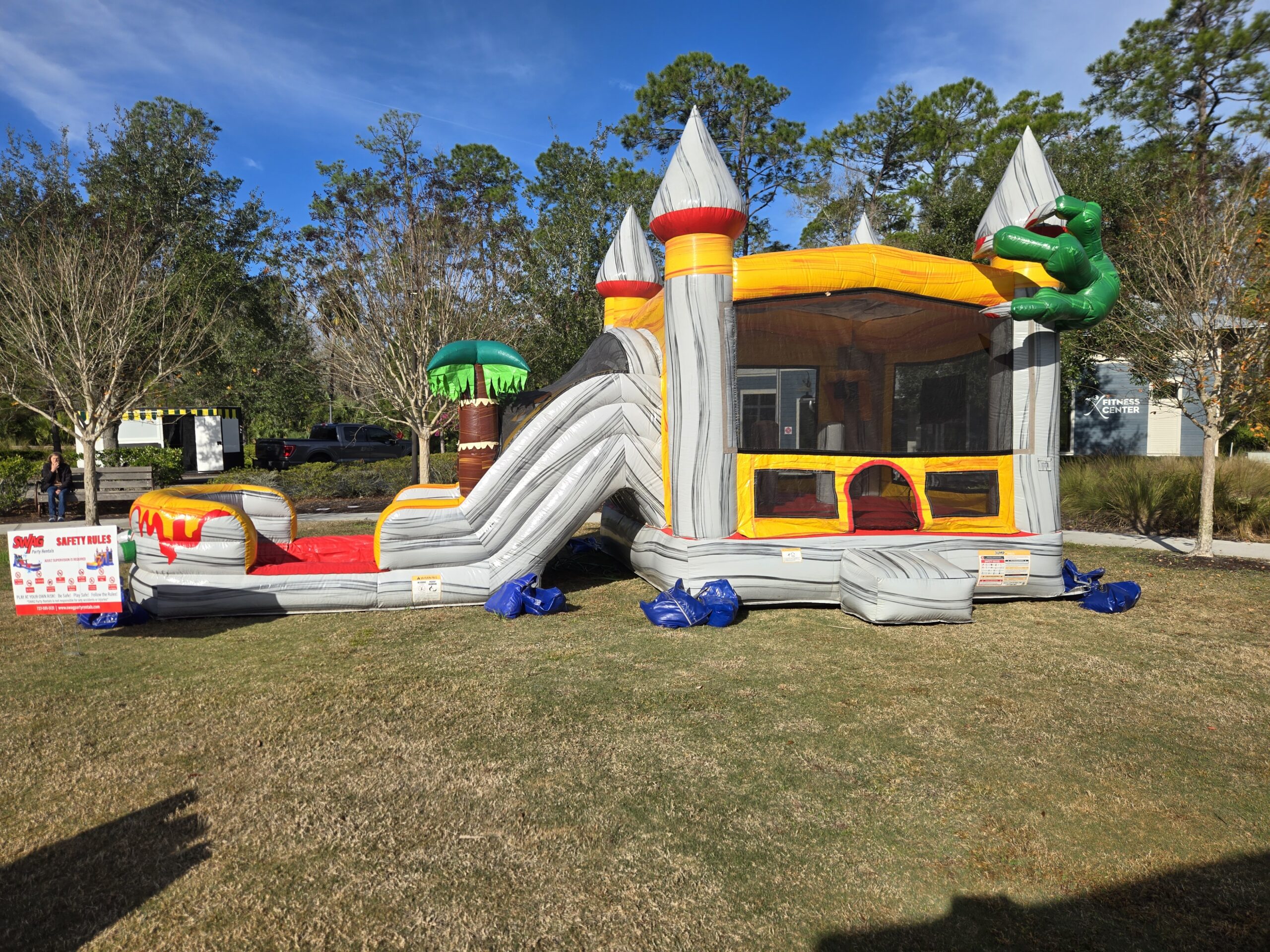bounce house and water slide party rental setup in Trinity Florida backyard