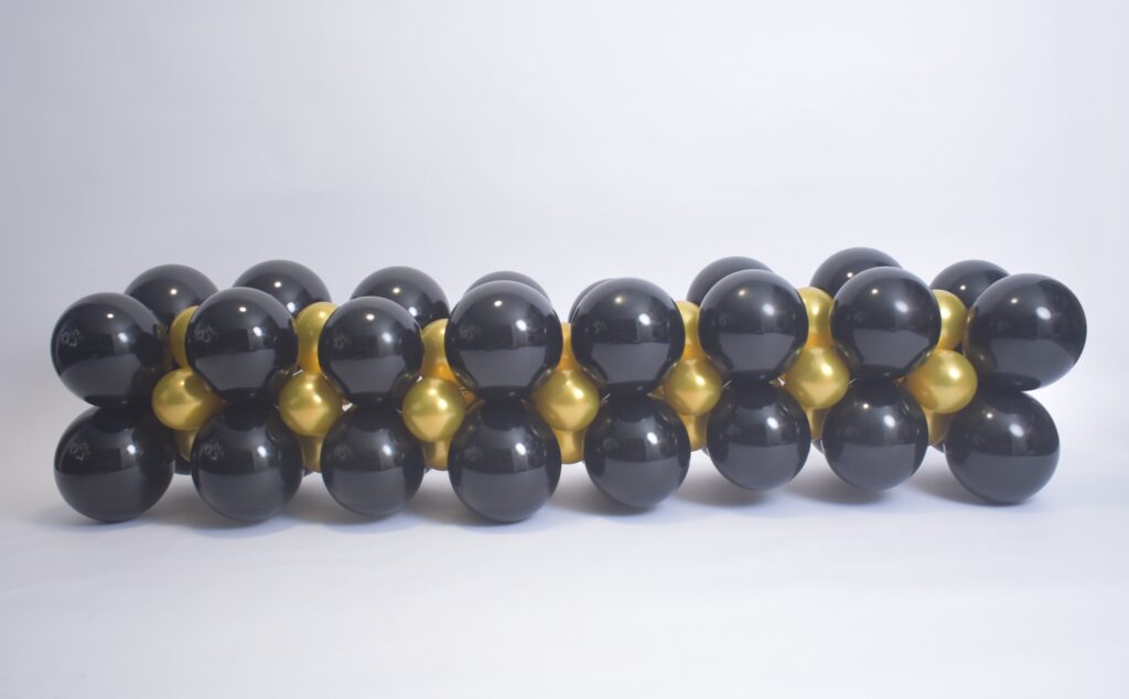 Balloon table runner and centerpiece setup in Odessa FL for party table decoration