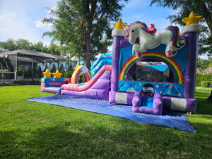 Unicorn birthday party setup in Trinity FL with bounce house and decorations
