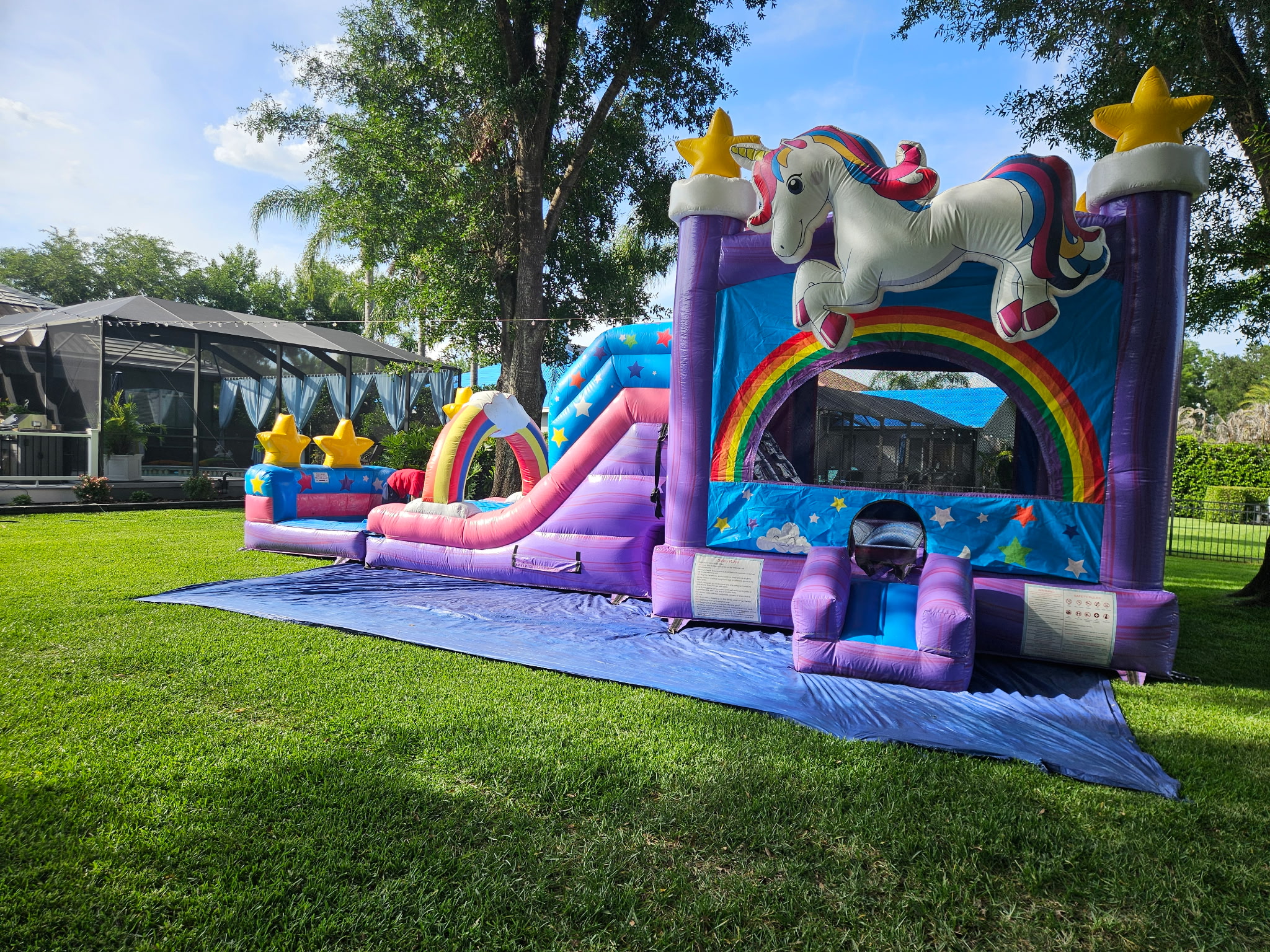 Unicorn birthday party setup in Trinity FL with bounce house and decorations